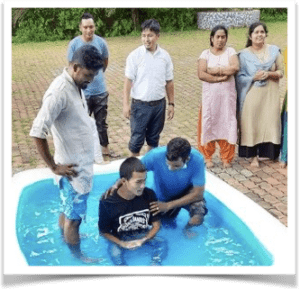 Brother in India baptizing new believer